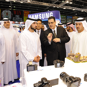 Visitors and guests at a GITEX Shopper consumer-electronics display.