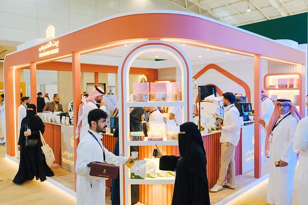 Visitors connect at a hospitality exhibition stand.